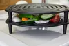 A close-up shot of a black metal grill rack with sliced vegetables inside. Produktbild-Vorschau