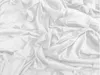 A close-up, top-down view of a crumpled white bedsheet. Náhľad obrázku produktu