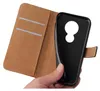 A hand holding a black phone case that is part of a brown flip cover case. Produktbild-Vorschau