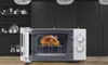 A roasted chicken is inside a white microwave oven, which is open. Anteprima dell’immagine prodotto