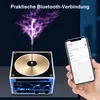 A person is holding a smartphone next to a mini Bluetooth speaker that is emitting a plasma arc effect. Produktbild-Vorschau