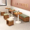 A coffee shop interior with tables, benches, and stools. Produktbild-Vorschau