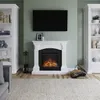 A living room scene featuring a white fireplace with an electric fire, flanked by two white bookshelves, and a television mounted above the fireplace. Produktbild-Vorschau
