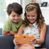 Two children are sitting on a couch, looking at a tablet. Produktbild-Vorschau