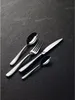 Cutlery arranged diagonally on a dark textured surface. Produktbild-Vorschau