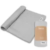 A rolled-up grey swaddle blanket and a packaged swaddle blanket are shown on a white background. Náhľad obrázku produktu