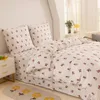 A neatly made bed with floral patterned bedding. Produktbild-Vorschau