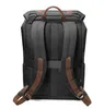 The back view of a black backpack with brown accents. Produktbild-Vorschau