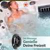 A woman relaxing in a hot tub with water jets spraying. Produktbild-Vorschau