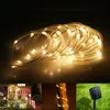 A collage of images showing solar-powered LED rope lights, a decorated house with Christmas lights, a tree wrapped in lights, and a solar panel in the grass. Produktbild-Vorschau