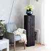 A modern living room corner with a chair, a wooden pedestal, and a vase of flowers. Anteprima dell’immagine prodotto