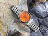 A watch is placed on a map with rocks. Voir les images du produit
