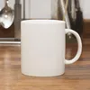 A white ceramic mug with a handle sits on a wooden surface. Produktbild-Vorschau