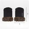 Two black mittens with brown fur trim are displayed side-by-side against a white background. Dimensions are indicated with measurement lines and text. Produktbild-Vorschau