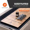 A close-up view of a shuffleboard table with pucks and a can of wax. Voir les images du produit