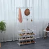 A white metal garment rack with four shelves for shoes, a pink scarf, and a brown hat hanging on it, placed in front of sheer white curtains. Anteprima dell’immagine prodotto