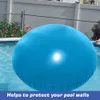 A large blue inflatable pool cushion floats in a swimming pool, with a fence and some greenery in the background. Produktbild-Vorschau