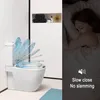 A toilet seat with a blue sky design is shown in a bathroom setting, next to a sleeping person. Produktbild-Vorschau