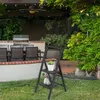 A backyard patio scene with a grill, dining set, and a folding step stool. Voir les images du produit