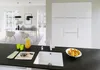 A modern kitchen with a sink, cabinets, and a dining area visible in the background. Produktbild-Vorschau