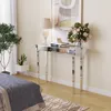 A mirrored console table with a lamp, books, and a floral arrangement in a modern living room setting. Podgląd zdjęcia produktu