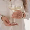 A person holding a glass of prosecco. Produktbild-Vorschau
