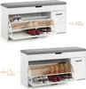 Two views of a white shoe cabinet with a gray upholstered seat, showing different shoe storage configurations and dimensions. Voir les images du produit