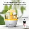 A humidifier with a unique egg-like design, emitting mist, with a bottle of essential oil next to it. Produktbild-Vorschau