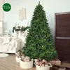 A decorated Christmas tree in a living room setting with gifts underneath. Produktbild-Vorschau