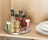 A rotating tray with spice bottles and oil/vinegar dispensers on a shelf. Anteprima dell’immagine prodotto