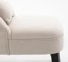 Close-up view of a cream-colored armchair with a textured fabric and a dark wooden leg. Produktbild-Vorschau
