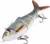 A realistic fishing lure shaped like a segmented fish with multiple hooks, presented against a plain white background. Podgląd zdjęcia produktu