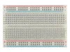 A top-down view of a white breadboard with blue and red power rails. Anteprima dell’immagine prodotto