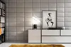 A modern living room setup with a bookshelf, a console table, a lamp, and a framed picture on a paneled wall. Produktbild-Vorschau