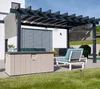 An outdoor patio scene with a pergola, a storage box, and seating. Podgląd zdjęcia produktu