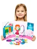 A young girl is holding a magnetic dress-up doll set. Produktbild-Vorschau