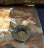 A close-up of a Stihl sprocket, likely a replacement part for a chainsaw, resting on its original packaging. Produktbild-Vorschau