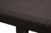 A close-up view of the edge of a dark brown rattan-look table. Produktbild-Vorschau