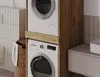 A stacked washing machine and dryer unit in a bathroom setting. Náhled obrázku produktu