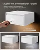 A collage showing a white floating nightstand with a drawer, demonstrating its lighting features. Produktbild-Vorschau