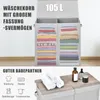 A split image showing a large, two-compartment laundry basket filled with folded clothes on the top half, and a close-up of the lid with towels and toiletries on the bottom half. Produktbild-Vorschau