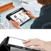 A person is using a tablet to draw fashion designs. The tablet is in a case, and there are art supplies on the table. Náhľad obrázku produktu