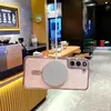 A pink phone case with a magnetic charger attached is hanging in what appears to be a cafe or restaurant. Náhled obrázku produktu