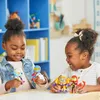 Two young girls are playing with action figures at a table. Podgląd zdjęcia produktu