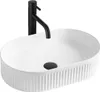 A white oval basin with a black faucet. Náhled obrázku produktu