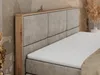 A close-up view of a bed with a beige upholstered headboard and a white mattress. Produktbild-Vorschau