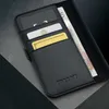 A close-up view of a black leather wallet with cards and cash inserted, resting on a textured gray and black surface. Anteprima dell’immagine prodotto