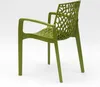 A green plastic chair with an intricate, web-like backrest is shown from a side angle against a white background. Voir les images du produit
