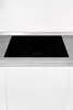 A black induction stovetop with four cooking zones and a digital control panel is shown embedded in a kitchen countertop. Produktbild-Vorschau