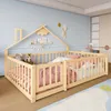 A child's bed with a house-shaped frame and protective railings, set in a bedroom with a blue wall and a colorful rug. Voir les images du produit